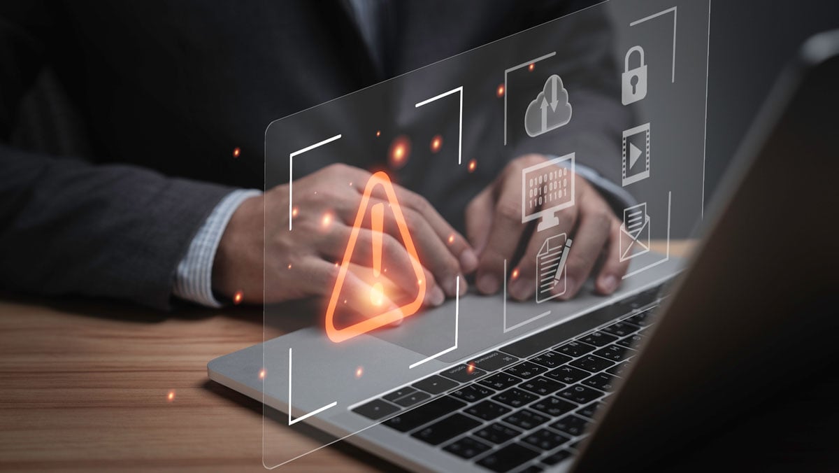 Cybersecurity risks common in finance shown on a laptop.