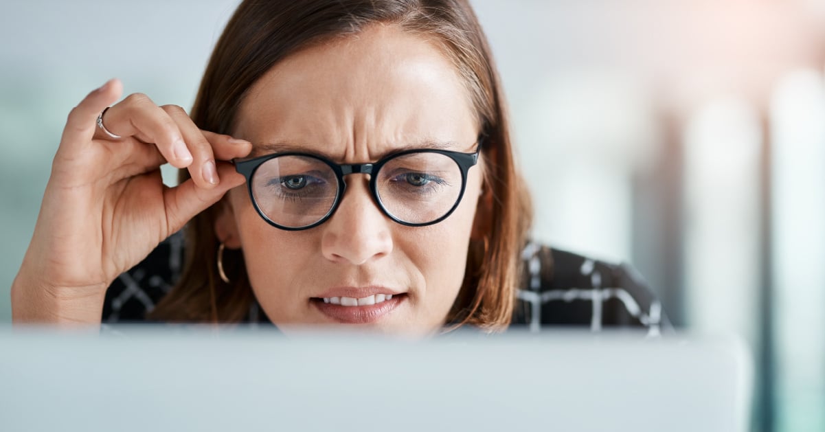 Confused employee looking at computer.