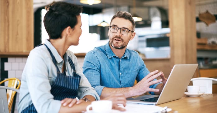IT specialist advising business owner. 