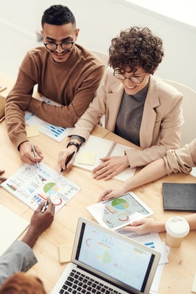 Business meeting with printed charts.