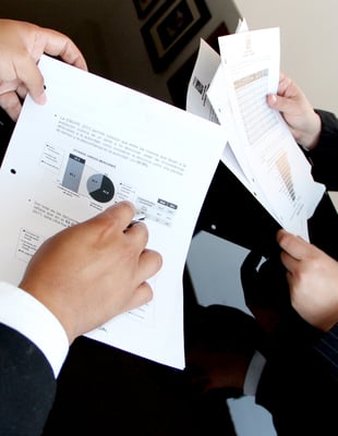 Employees looking at printed data. 