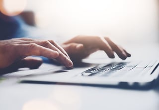an individual typing on a keyboard
