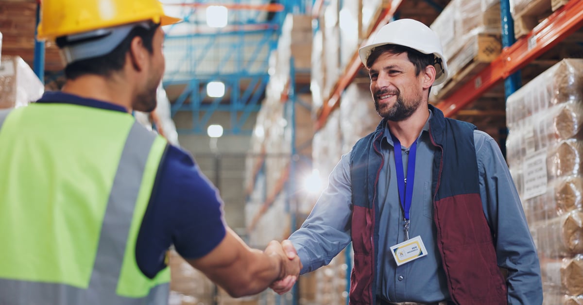 Warehouse workers shaking hands. 