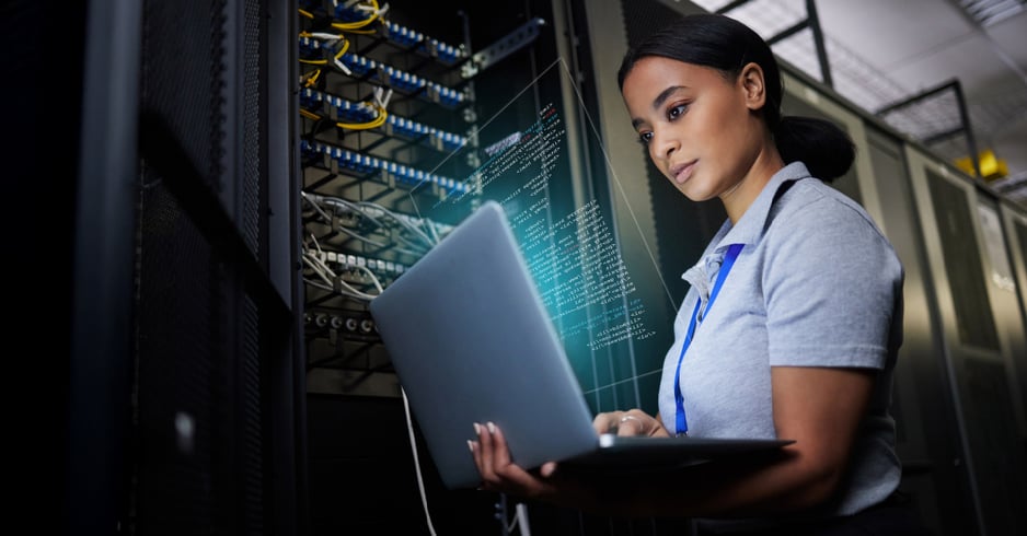 A female IT pro assesses her business's network performance. 