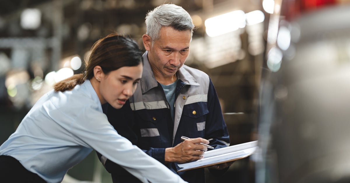 Manufacturing employee working with print tech.  