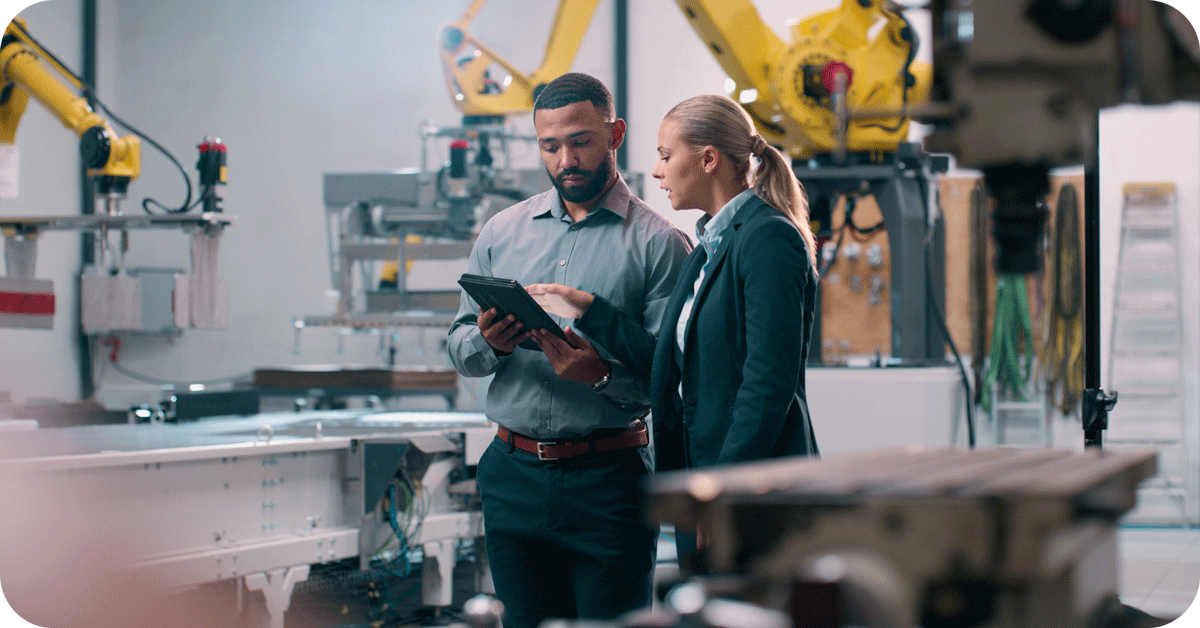 IT specialist conversing in factory